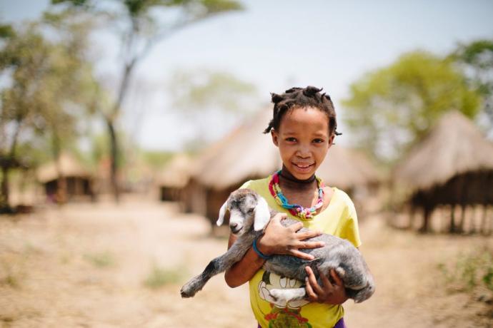 Girl holding a baby goat