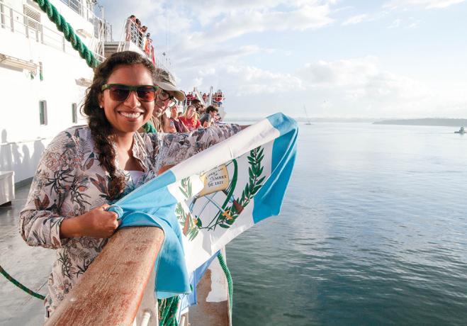 young woman holds flag onboard the Logos ship