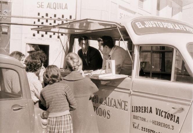 Literature is distributed from a van in 1960 Spain