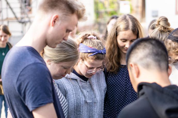 Team members are praying before going on outreach