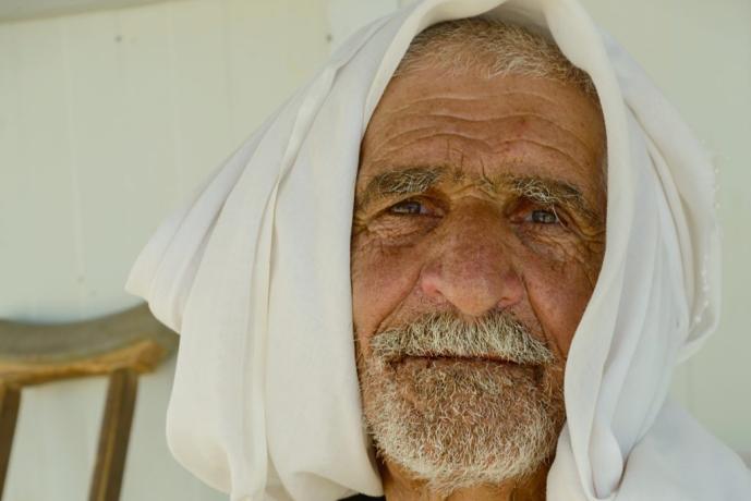 portrait of an elderly Syrian refugee