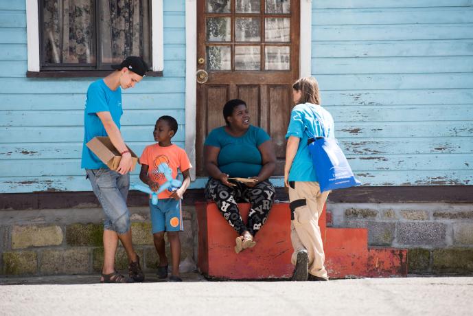 Crewmembers connecting with a local woman in Grenada during a former visit to Grenada..