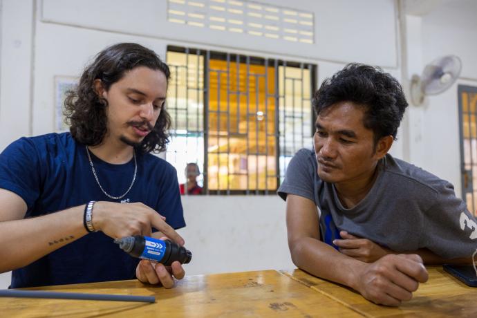 	 Sihanoukville, Cambodia :: Daniel (Brazil) explains the function of the tools of the water bucket.