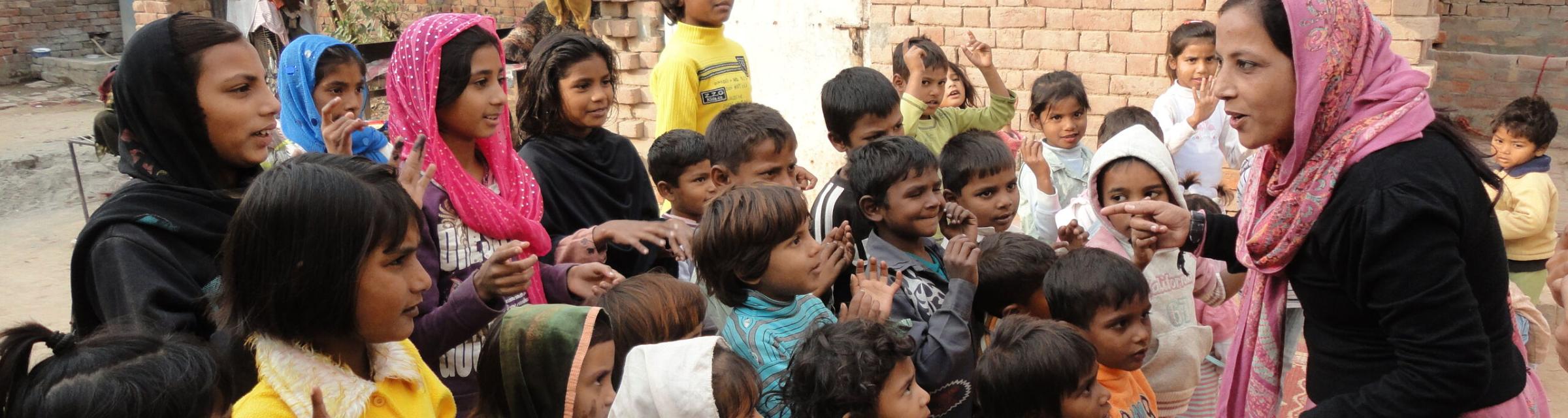 A woman asks children for their feedback after telling a story from the Bible. 