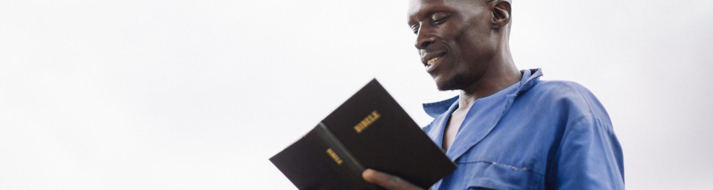 A Lesotho man reads publically from the Bible.