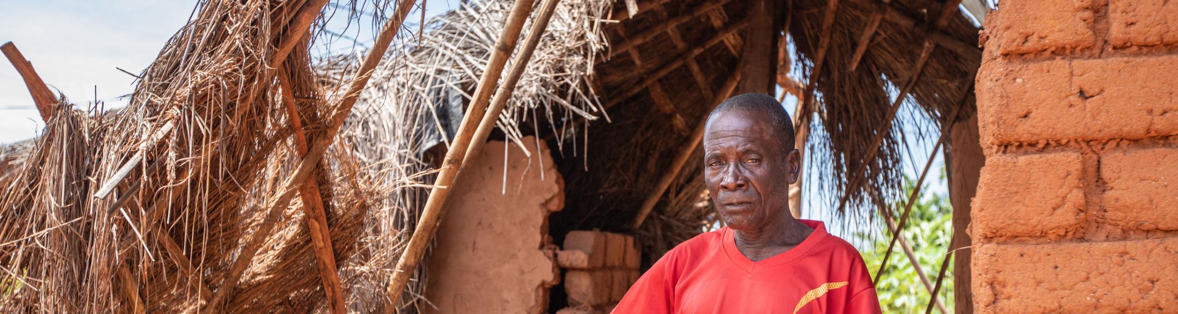 An elder stands in a home in his village that was damaged by the heavy rain and winds of Cyclone Idai in Mozambique. Photo by Rebecca Rempel