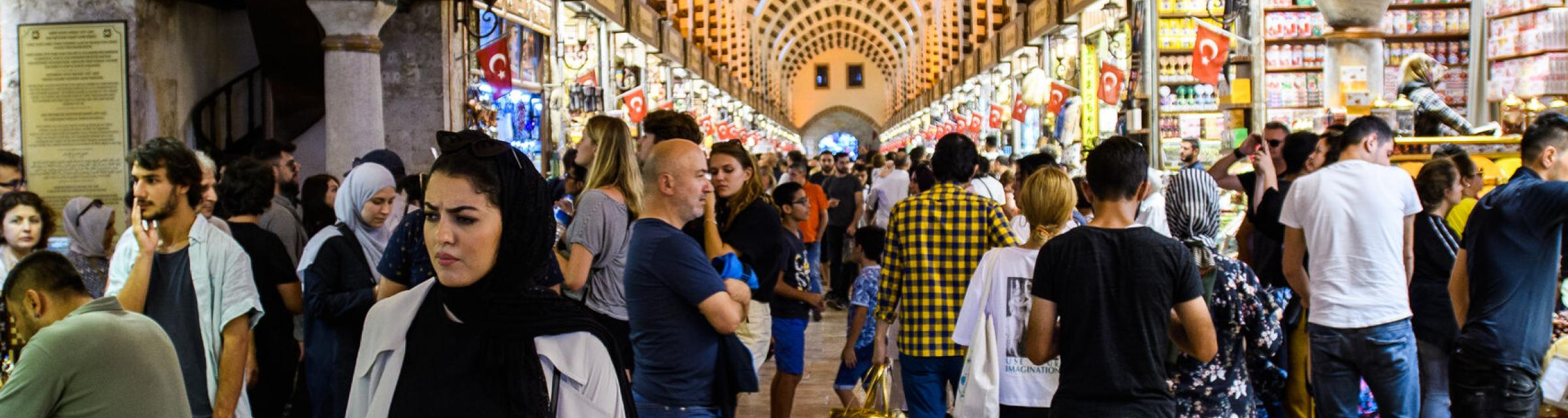 Locals and tourists busily pass by as they shop in a bazar in Turkey.  Photo by Garrett N