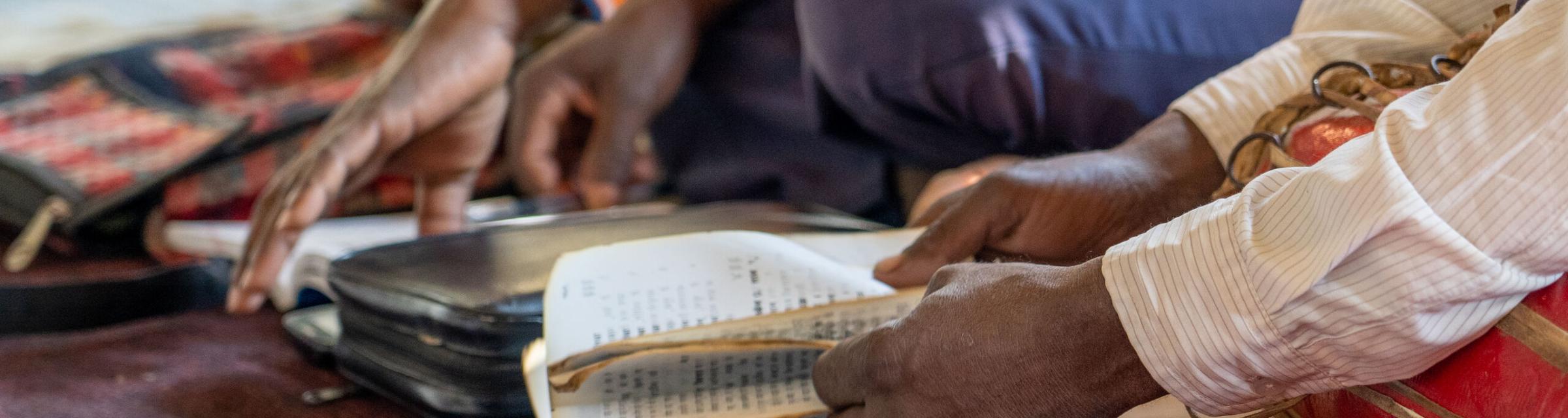 People page through the Bible. Photo by RJ Rempel.