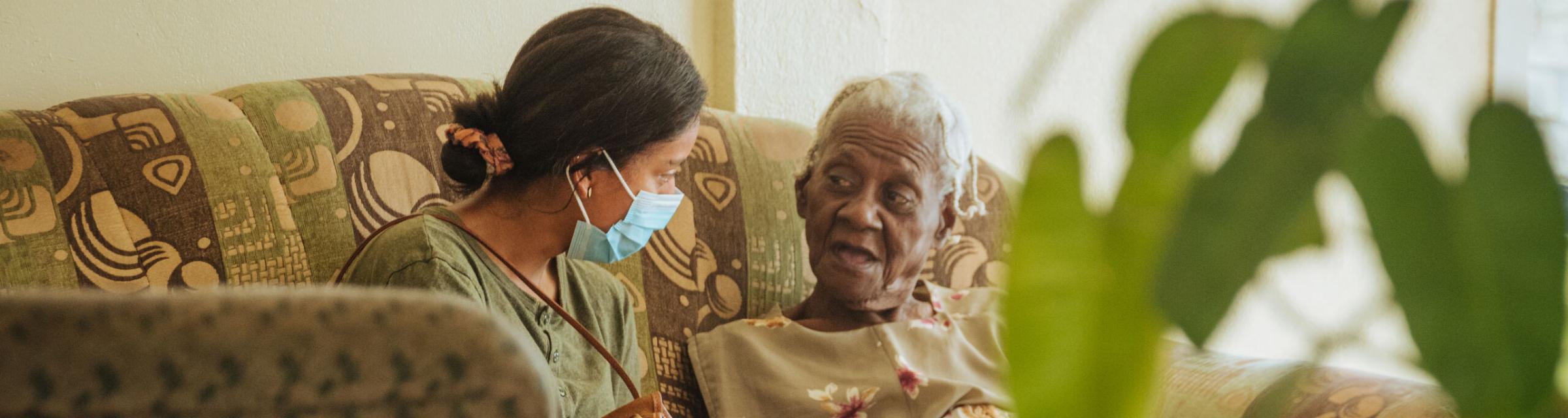 Castries, Saint Lucia :: Jessica Campos (El Salvador) talking with an elderly woman in a shelter.