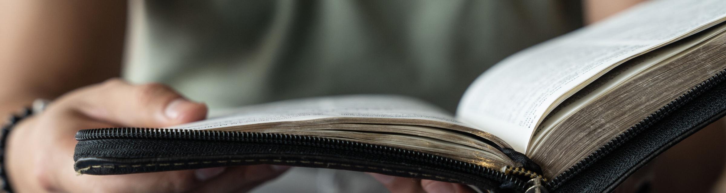 A man flips through a Spanish Bible. Photo by RJ Rempel.
