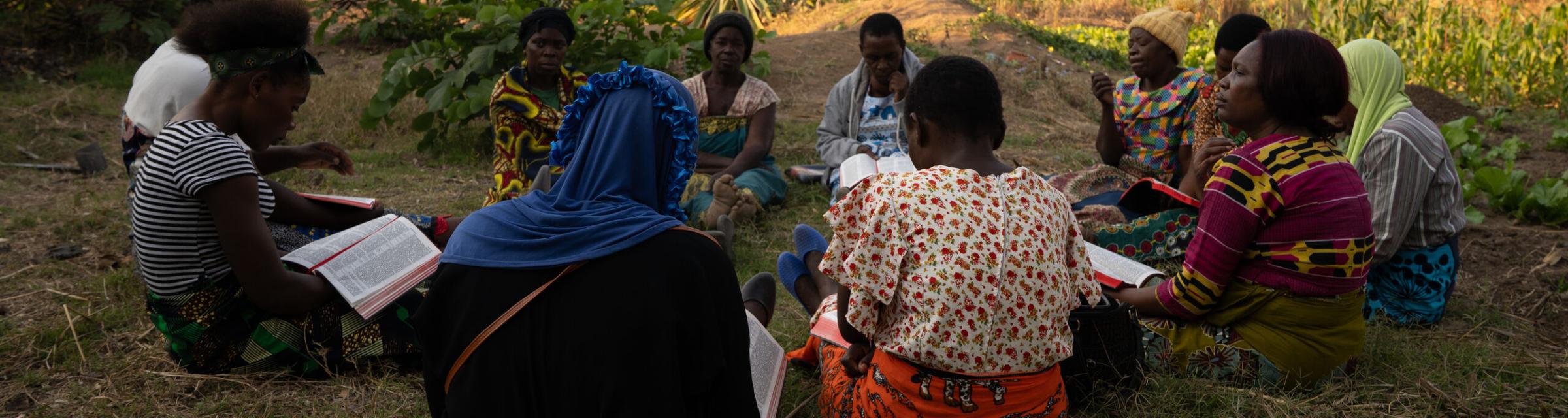 A group of women from an impoverished community in Malawi, gather together for a bible study. They are part of a self-help group that empowers women to help other women.