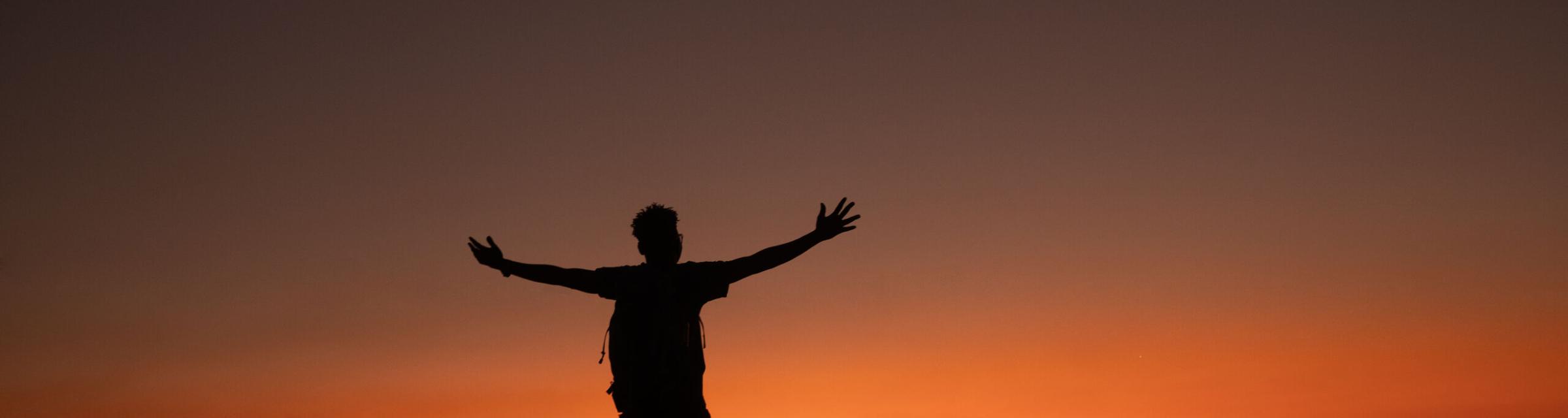 A silhouetted figure at sunset in Malawi. Photo by Ellyn Schellenberg.