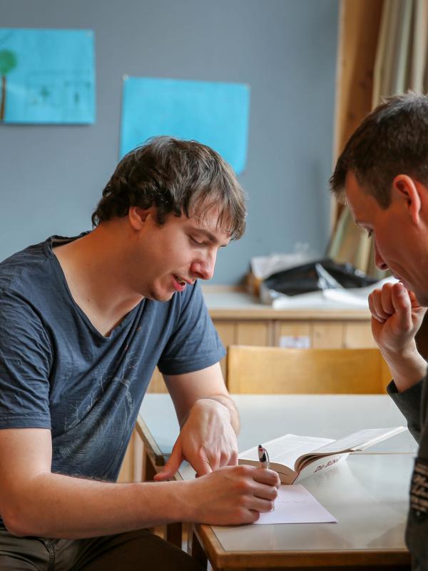 Two men reviewing notes together