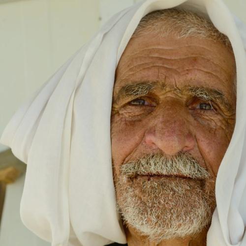 portrait of an elderly Syrian refugee