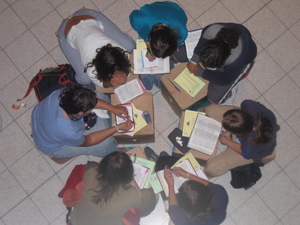 A small group (NET group) at TeenStreet Germany 2005. This group of teenagers with their leader (coach) are studying the bible together.