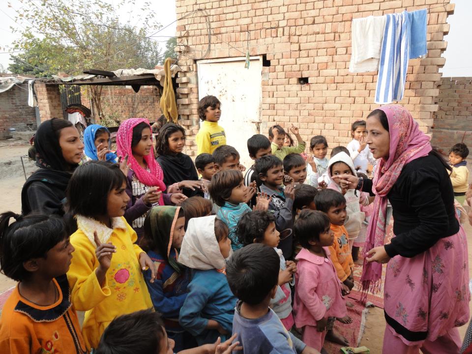 A woman asks children for their feedback after telling a story from the Bible.
