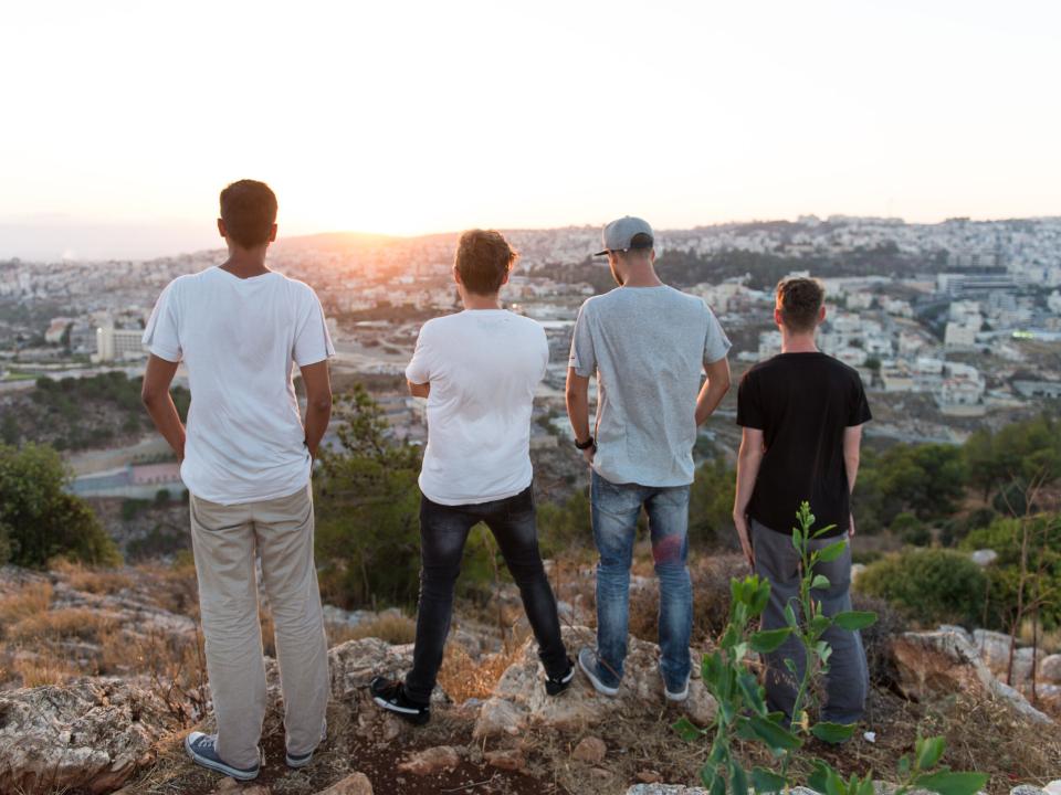 Members of the MENA Travelling Team look out over the city in Israel.
