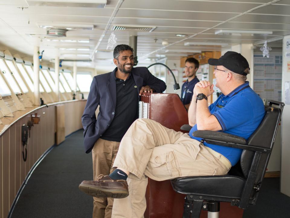 At Sea :: Logos Hope's Captain Tom Dyer (USA) and Director Seelan Govender (South Africa) talk on the Bridge.