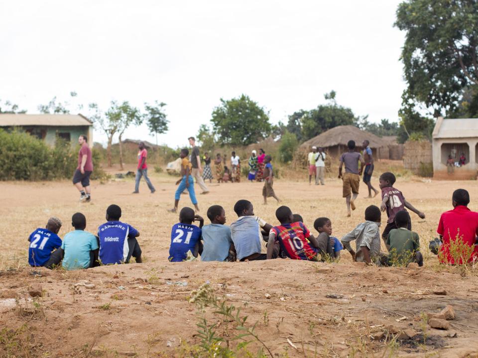 Bystanders watch a soccer game put on by the Africa Trek on outreach.