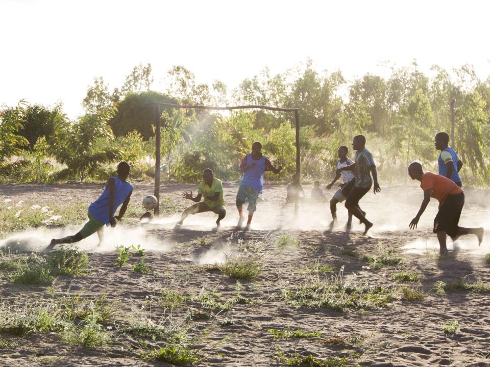 Disciples and locals play a game of soccer on the OM Malawi's base.
