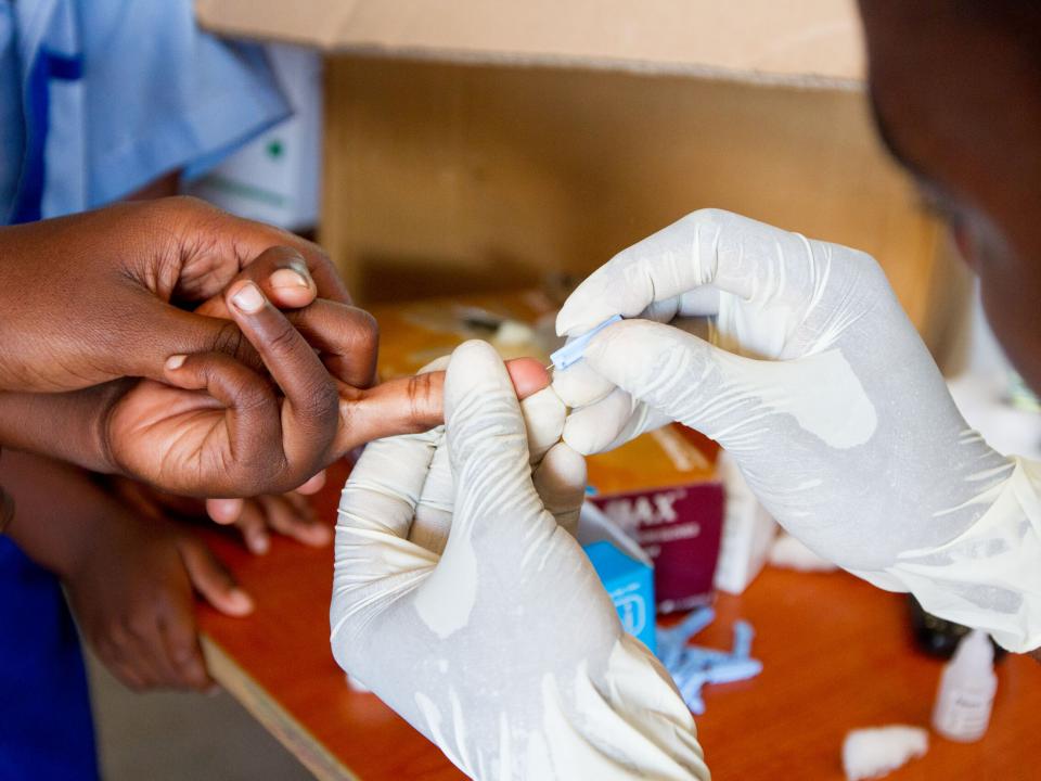 A government health care worker tests a student for HIV at The Good News II School at OM Lake Tanganyika.