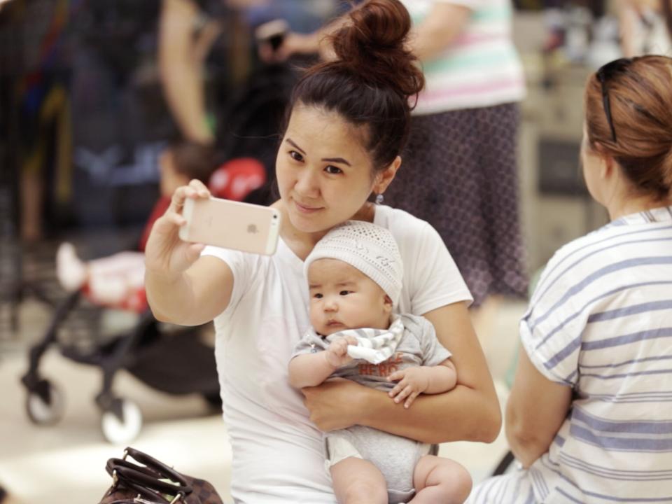 Technology is transforming Central Asia. A young mom snaps a selfie during a shopping trip at a local mall. Photo by Jay