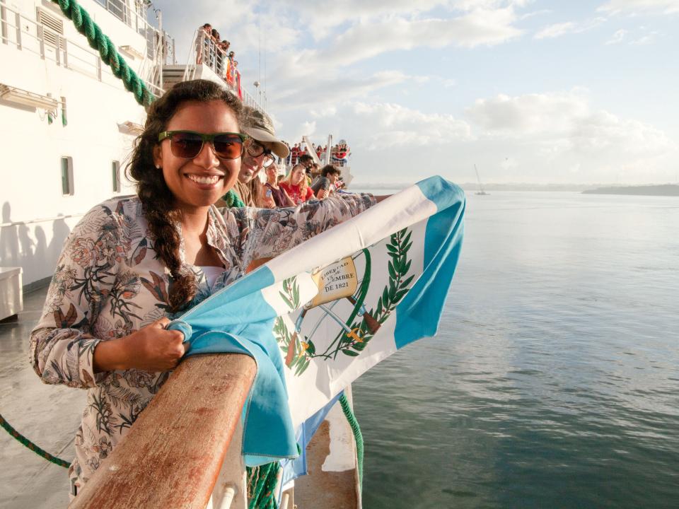 Puerto Barrios, Guatemala :: Ruth Schmutz (Guatemala) holds her flag as Logos Hope arrives in her country.