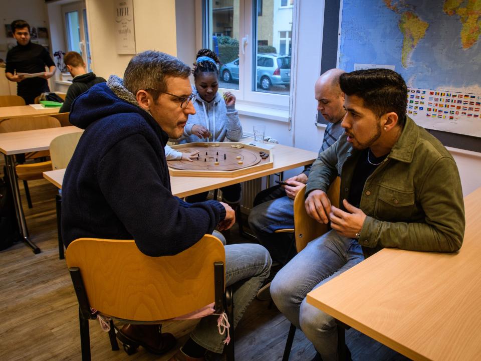 Talking with refugees in an international café.