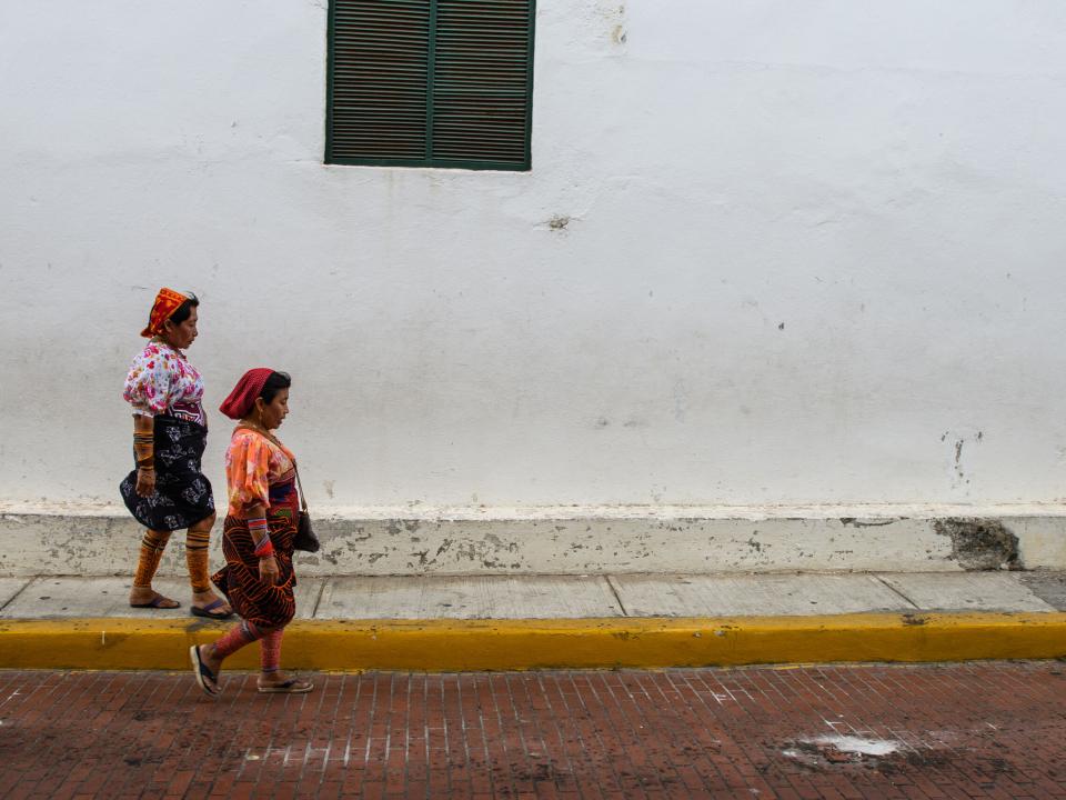 Traditionally dressed women walk down a street in Panama City.  Photo by Garrett N
