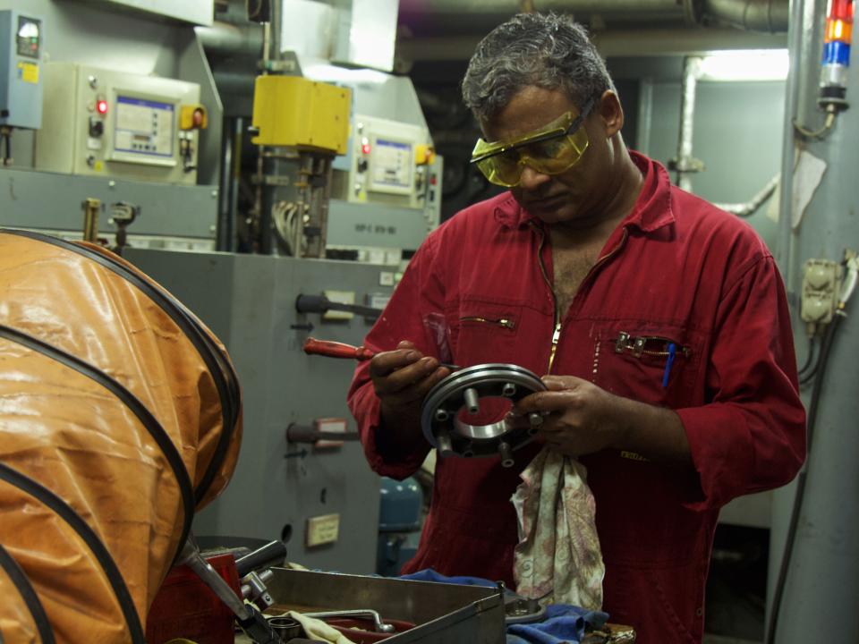 Veracruz, Mexico :: Prakash Anil (India) works on a machine part in the engine room.