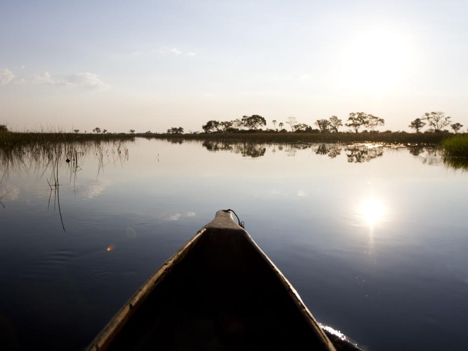 A canoe paddles on a lake.