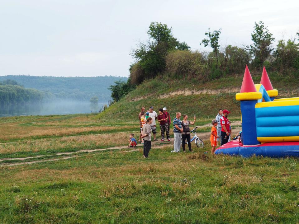 Drawn by the bouncy castle, children and parents start arriving at the campsite of a ‘River Adventure’ outreach team at the edge of a village where previous teams had not been allowed to do ministry, but this time were met with great openness. The ‘River 