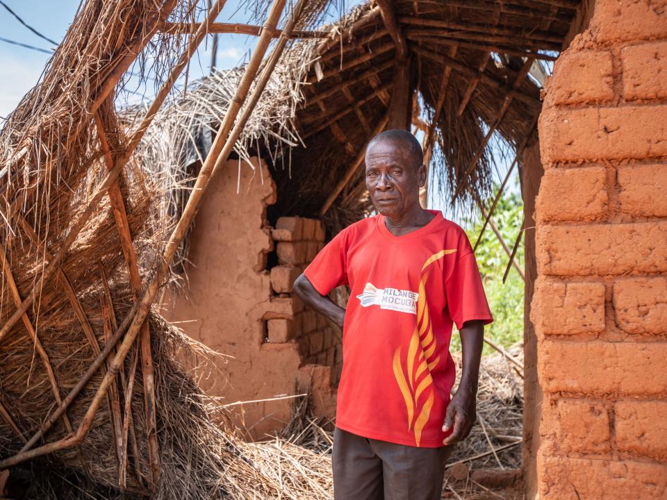 An elder stands in a home in his village that was damaged by the heavy rain and winds of Cyclone Idai in Mozambique. Photo by Rebecca Rempel