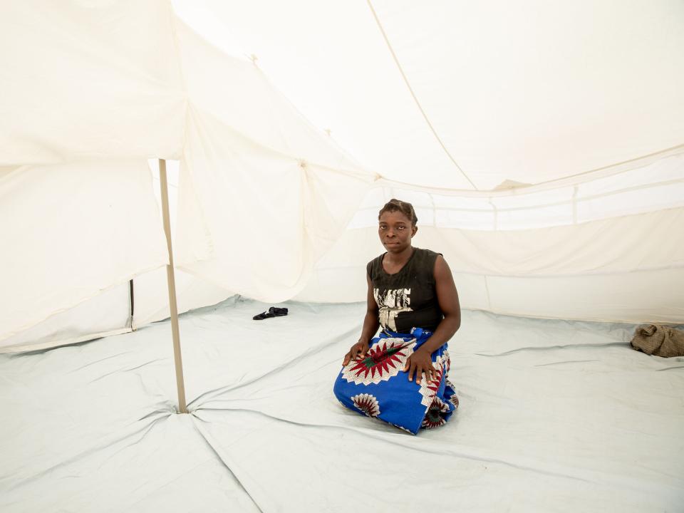 Amina, a widow and mother of five, by her tent. Amina's house, which used to be by the river, was destroyed by Cyclone Idai in Mozambique. She and her family have moved to a tent provided by the government on the outskirts of town. Photo by Rebecca Rempel