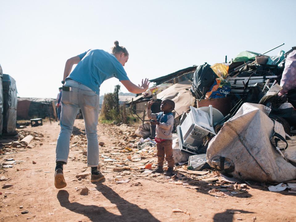 South Africa MDT Trainee connects with a local child at Plastic view informal settlement.