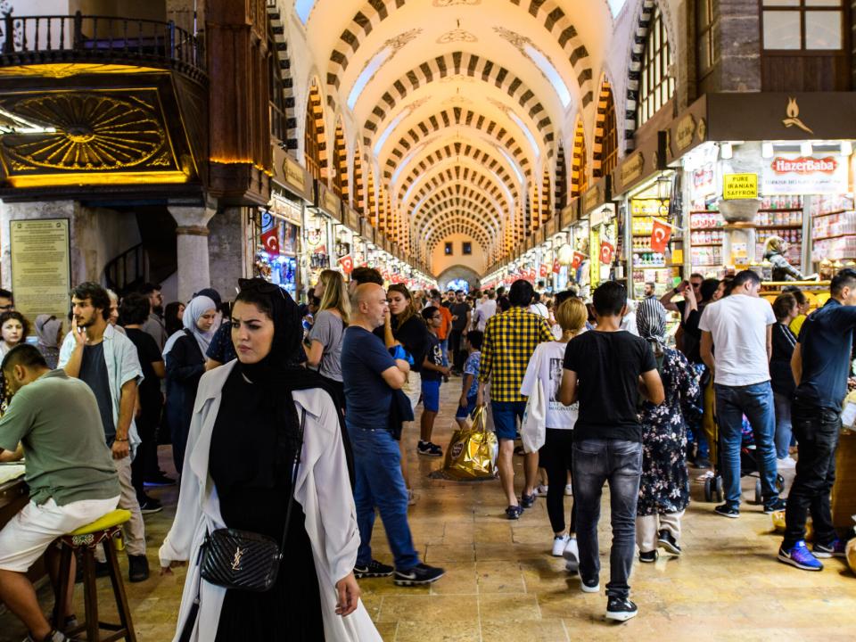 Locals and tourists busily pass by as they shop in a bazar in Turkey.  Photo by Garrett N