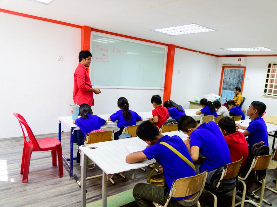 A school run by the team in Cambodia, this class is taking place in the new school building built from shipping containers.