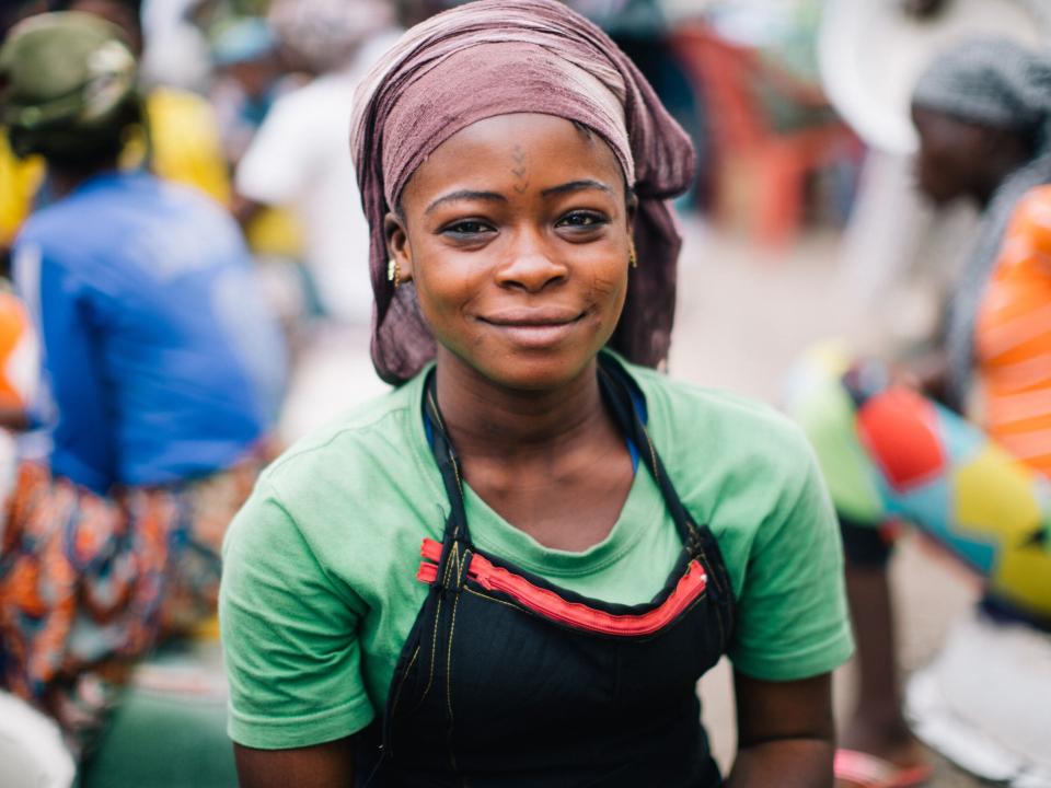 A woman smiles for a portrait in Ghana. Photo by Do Seong Park.