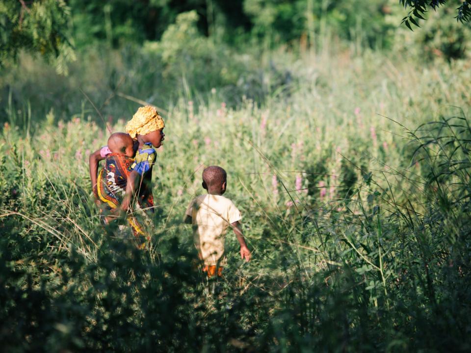 Children walk into the bush in Ghana. Photo by Do Seong Park.
