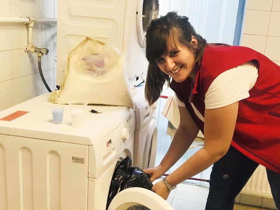 Lidia working in a laundry at a refugee camp in Serbia.