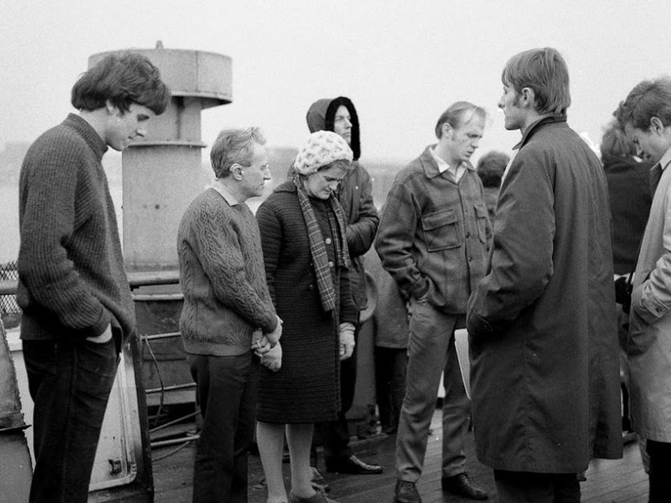 OM Ships :: OM's founder, George Verwer (second from right) and original crewmembers pray on the deck of Umanak, which would become the Ship Ministry's first vessel, Logos.