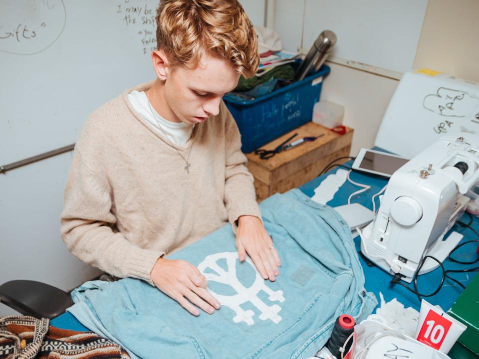 Ships :: Nathanael Wiebe (Canada) works on designing clothing during his free time on board.