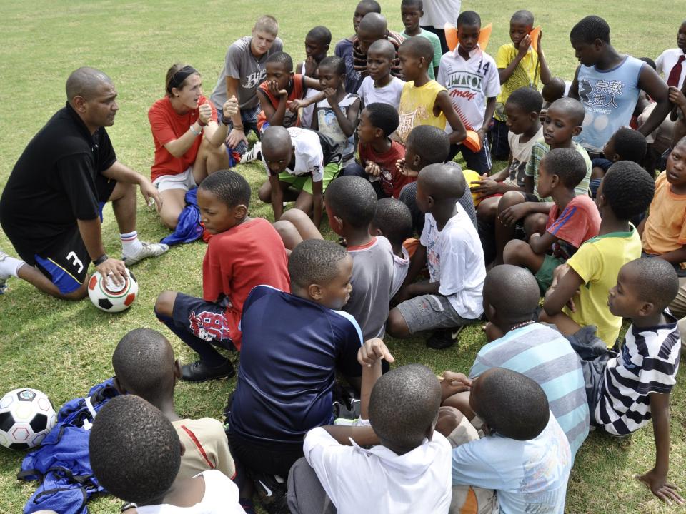 Encouraging school children during a break of soccer training in Zambia.