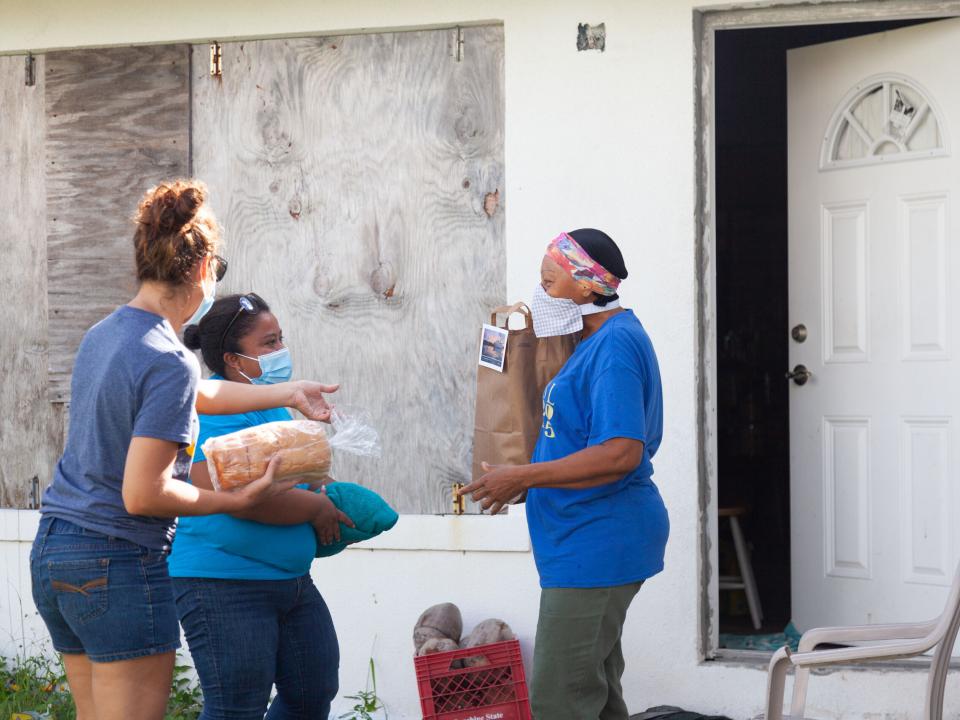 Freeport, The Bahamas :: Rosa Maria (Guatemala) and a volunteer share foods during food distribution