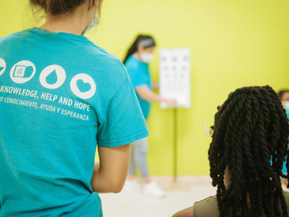 Freeport, The Bahamas :: Logos Hope crewmembers test the eyesight of a local woman.