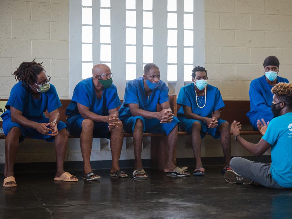 Vieux Fort, Saint Lucia :: Arione Miguel (Curaçao) shares his personal story with inmates as crew visit a prison.
