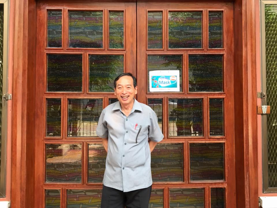 Pastor Winit stands in front of Immanuel Baptist Church, an OM partner committed to obeying Jesus' command to make disciples.