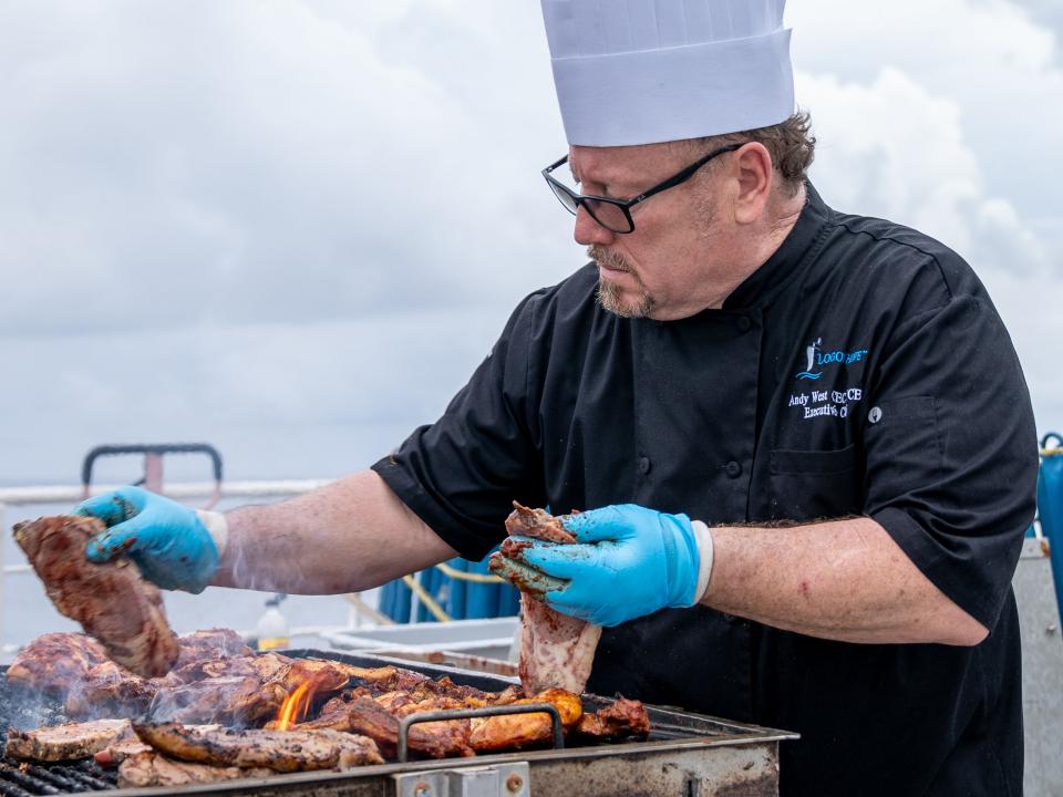 Freetown, Sierra Leone :: The chef of Logos Hope, Andy West (USA), prepares the meat for a crew barbeque.