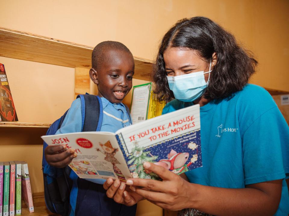 Freetown, Sierra Leone :: Dayanna Reyes (Ecuador) reads to a pupil in the new library crewmembers set up at Grace International School.
