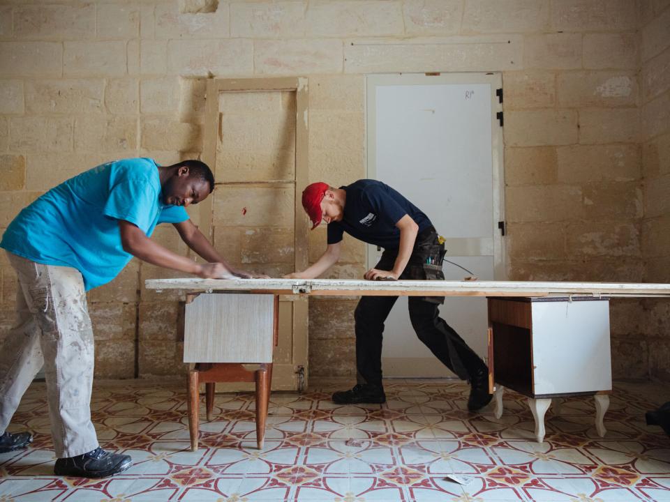 Valletta, Malta :: Crewmembers help with construction work at a refugee centre.